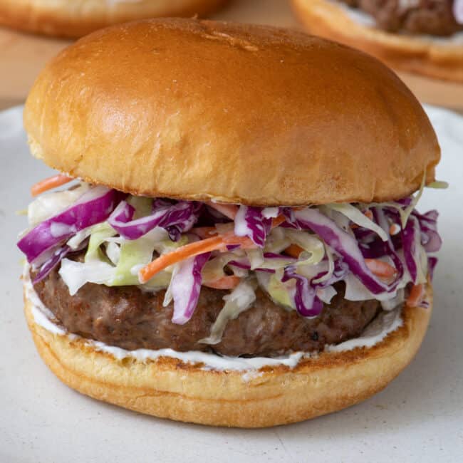 Side view of coleslaw on a burger.