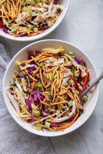 Top down shot of asian chicken salad in two bowls