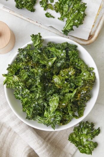Large bowl of kale chips with dipping sauce
