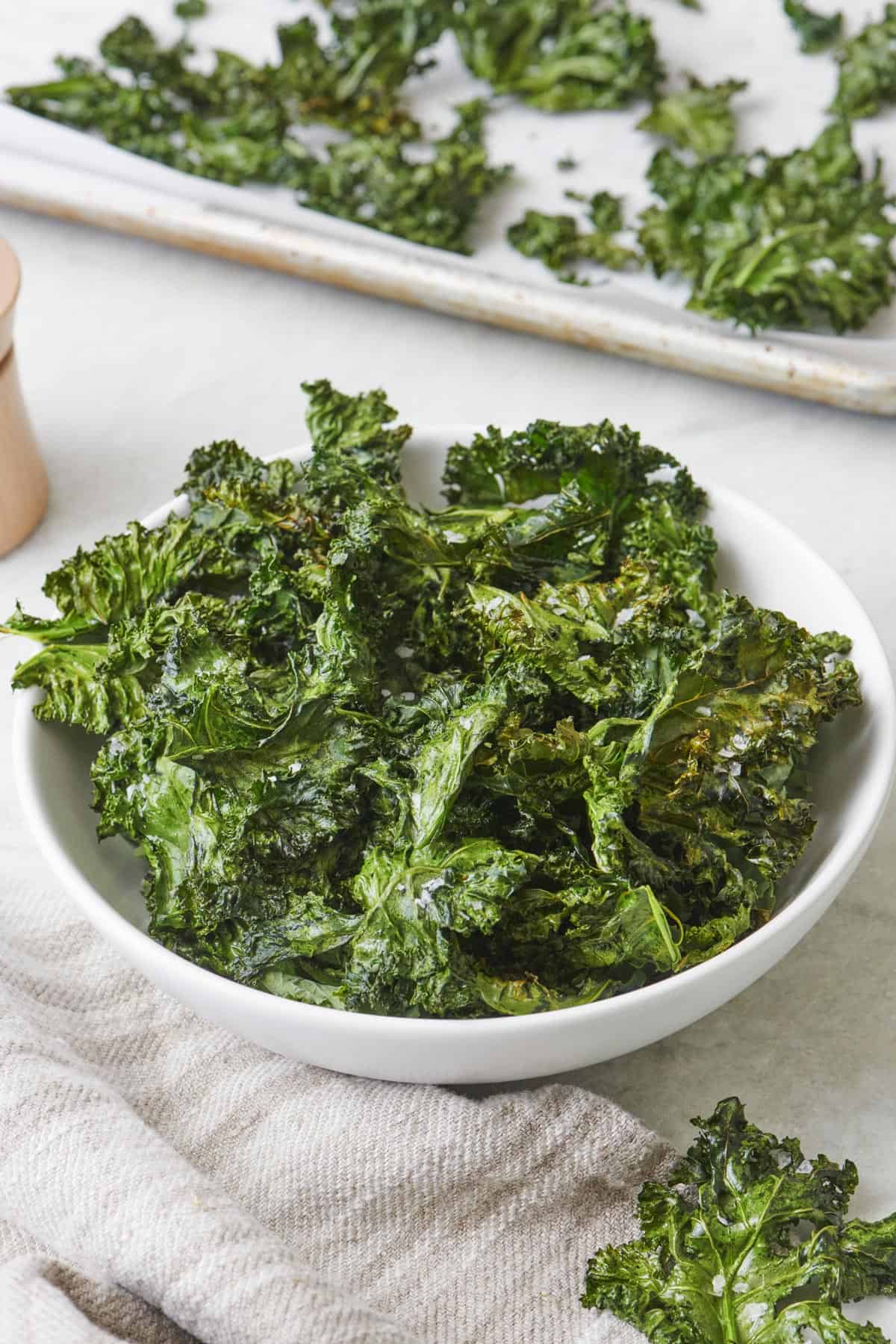 Close up shot of baked kale chips with dipping sauce