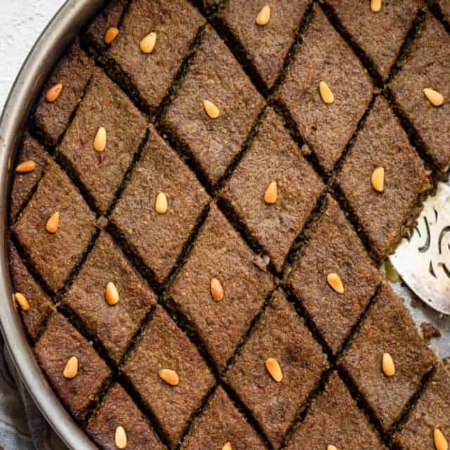 Baked kibbeh (also called kibbeh bil sanieh) topped with pine nuts
