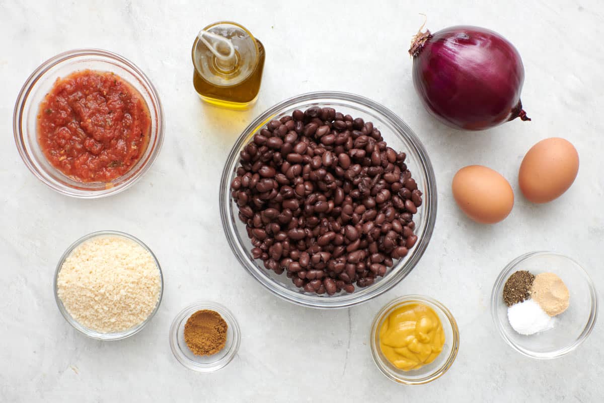 Ingredients to make the recipe: black beans, salsa, beaten eggs, breadcrumbs, red onions, cumin and mustard