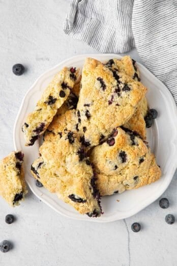 Plate of blueberry scones stacked on top of each other.