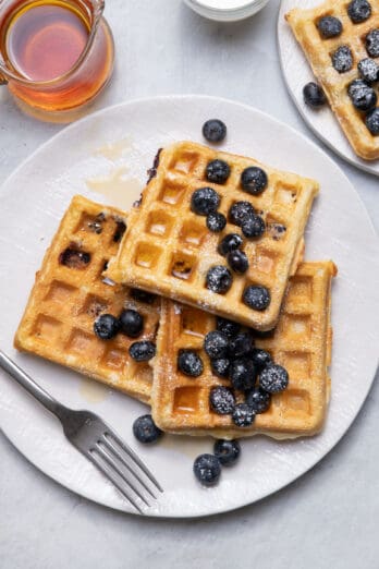 Blueberry yogurt waffles on plate with fork