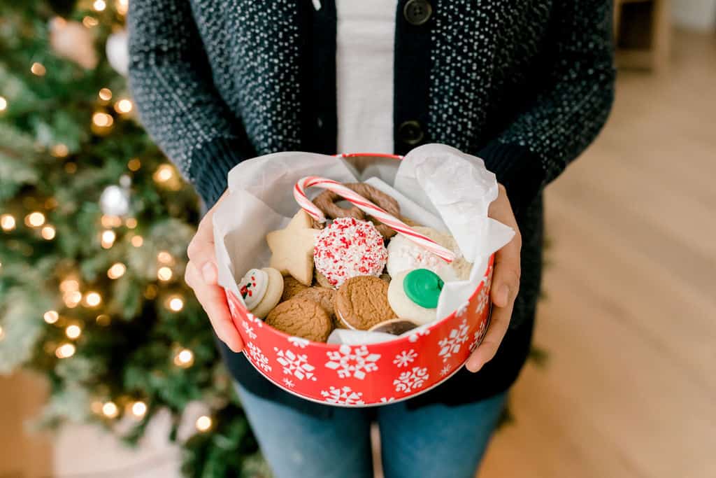 Holding box of cookies at cookie exchange party