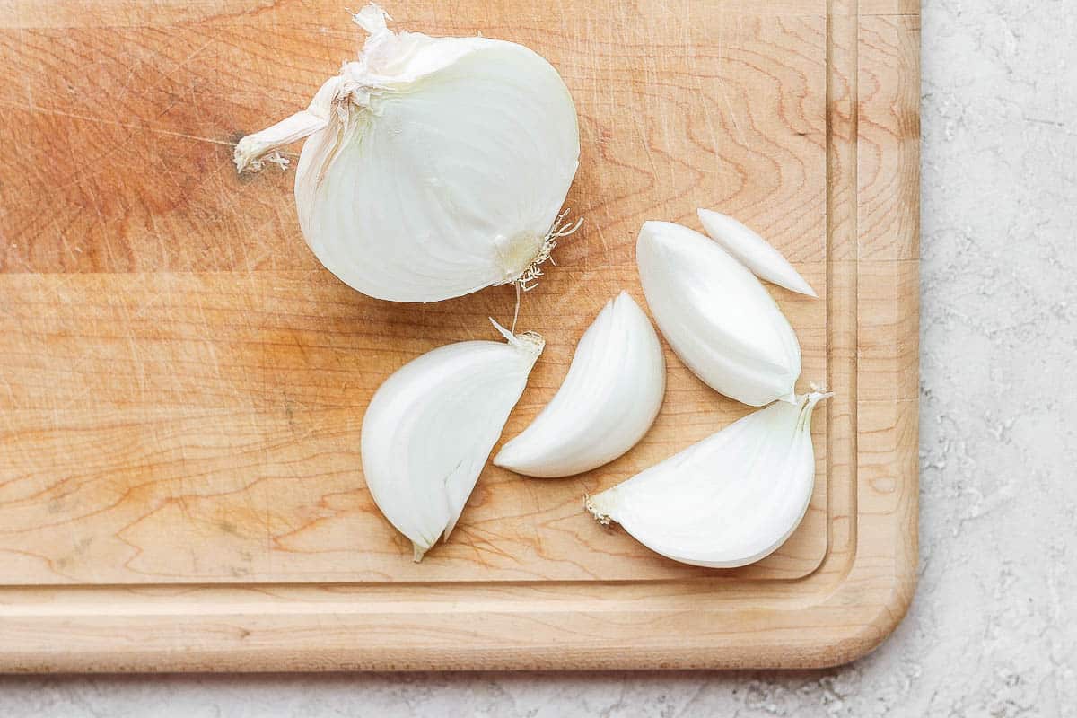 White onion cut in half and partially sliced.