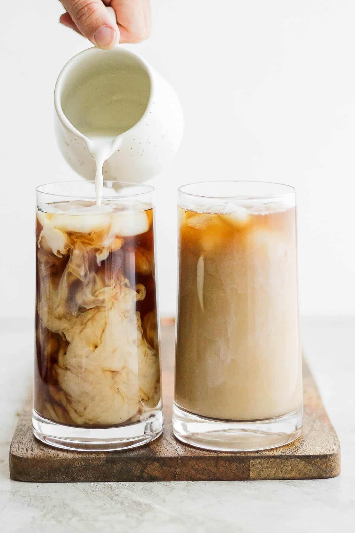 Pouring milk into cold brew over ice