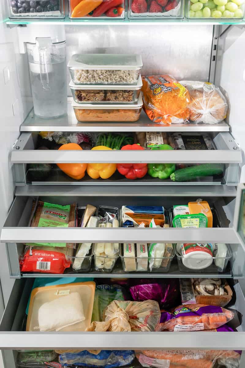 An organized fridge with the drawers open to show each area.