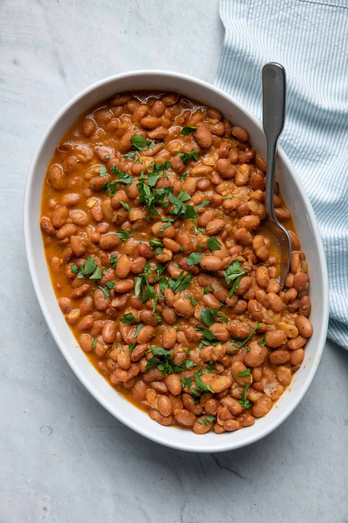 Large dish of instant pot baked beans garnished with parsley