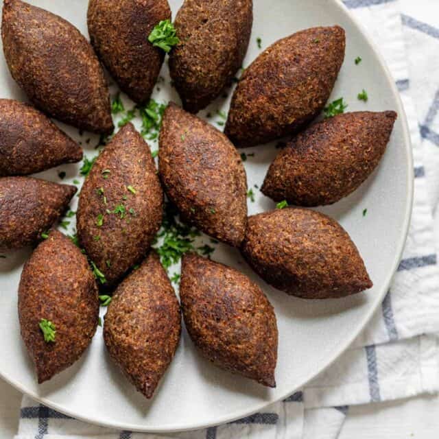 Kibbeh balls after fried on a white plate