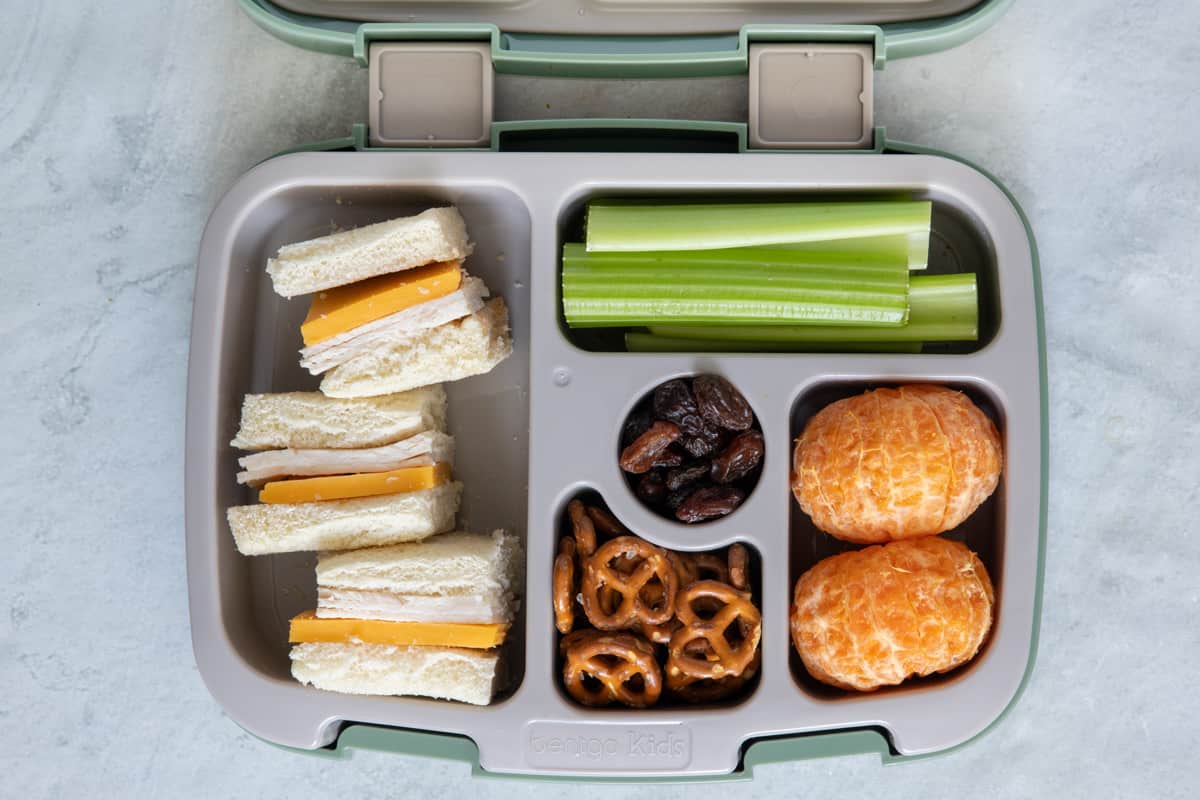 Lunchbox with individual sections with different lunch foods for kids: