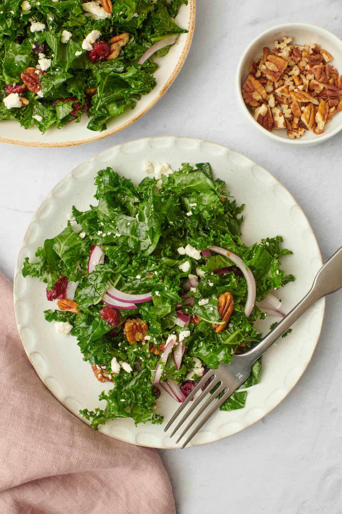 Easy kale salad on a plate next to platter.