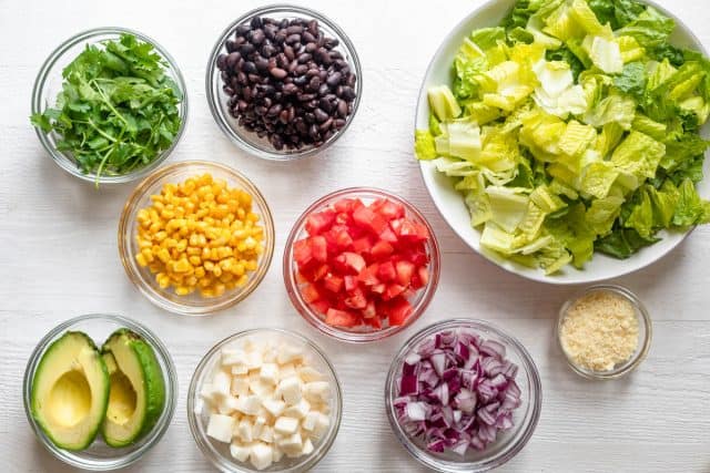 Ingredients to make the salad all in individual clear vowls