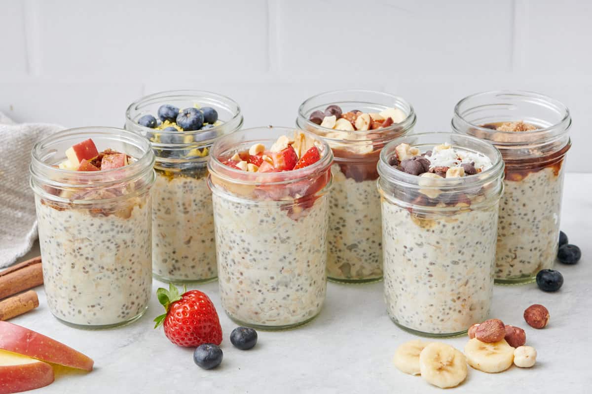 Peanut Butter & Jelly Overnight Oats with other glasses of overnight oats in the background