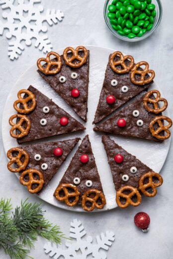 Large white platter of reindeer brownies cut up into triangles and decorated