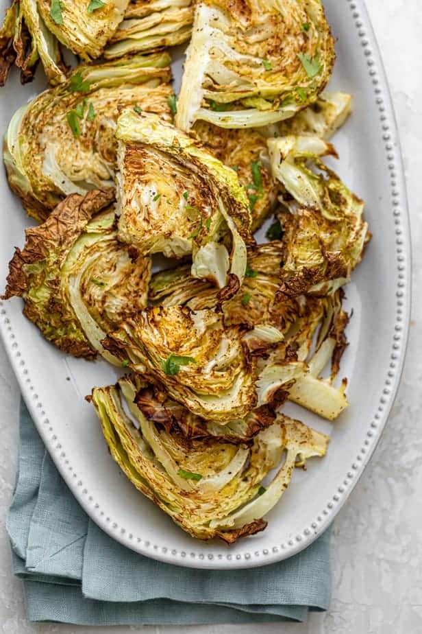 Roasted cabbage slices on a white plate