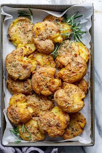 These Rosemary Garlic Smashed Potatoes are a best of both worlds potato recipe - mashed and roasted! They are soft on the inside, crispy on the outside and bursting with rosemary garlicky flavor. It's a creative healthy side-dish the whole family will love!