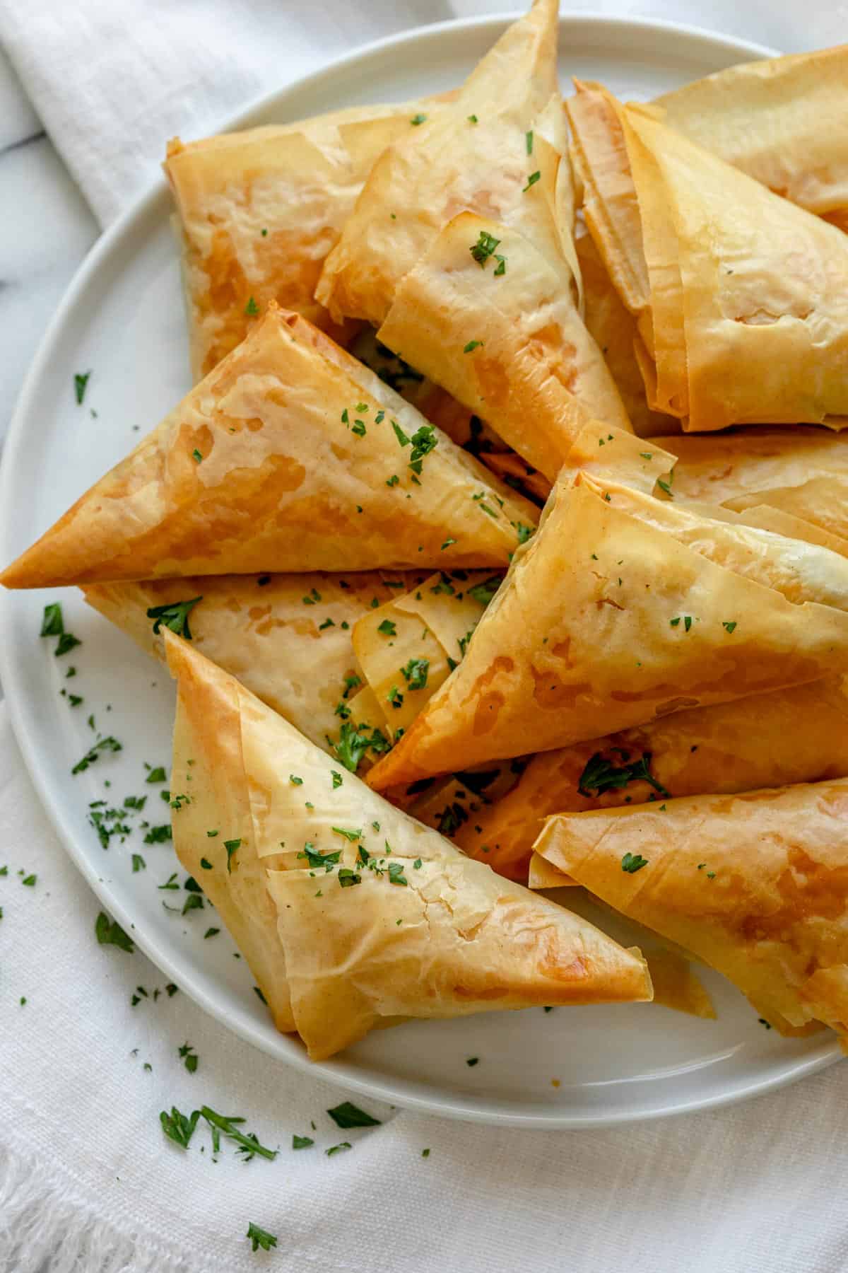 Spanakopita triangles after baking on a plate