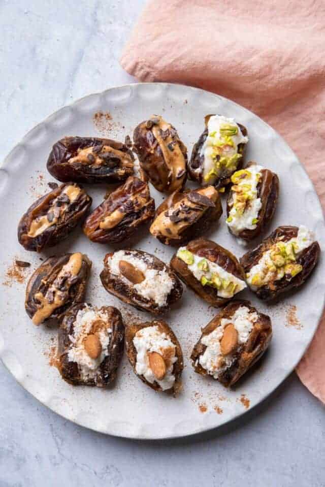 Large white plate of stuffed dates with different flavors