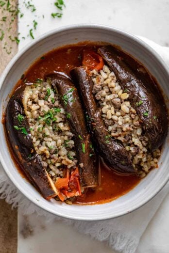 Final cooked stuffed eggplant cut in half to show the rice and beef stuffing