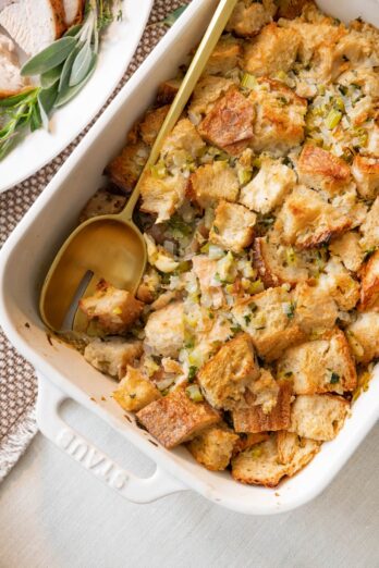 Stuffing in a baking dish with serving spoon.