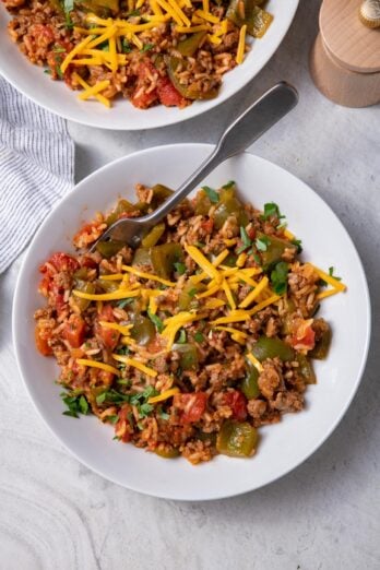 Two bowls of the unstuffed peppers recipes topped with cheese