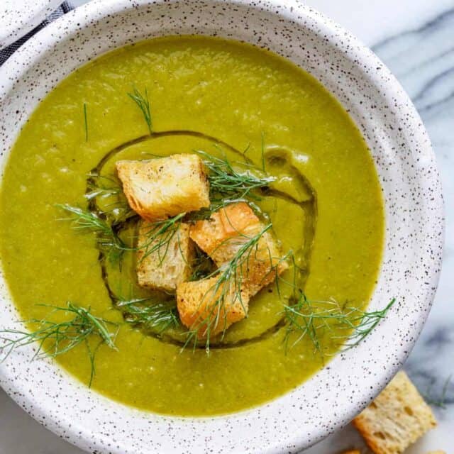 Large bowl of vegan broccoli soup with croutons on top