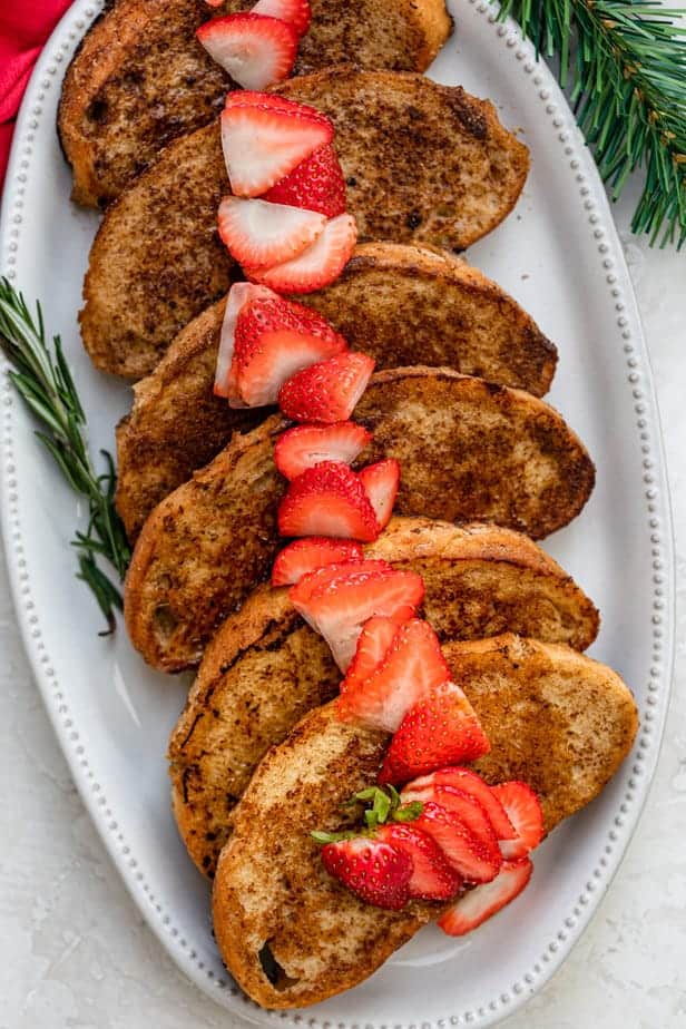 Eggless french toast for a crowd topped with sliced strawberries