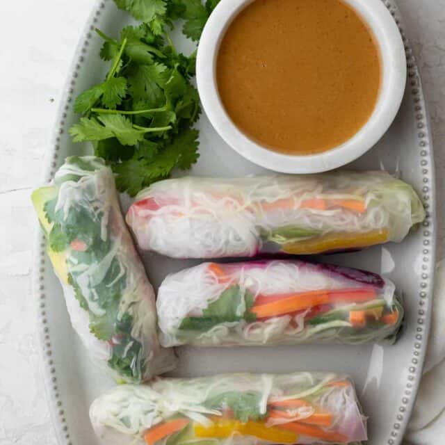 Platter of Vietnamese vegetable spring rolls with peanut dipping sauce