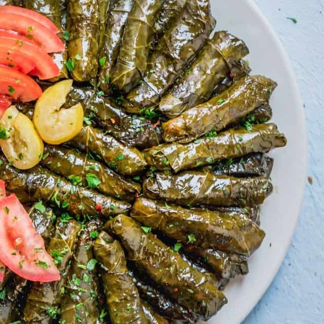 Large plate of rolled vegetarian stuffed grape leaves