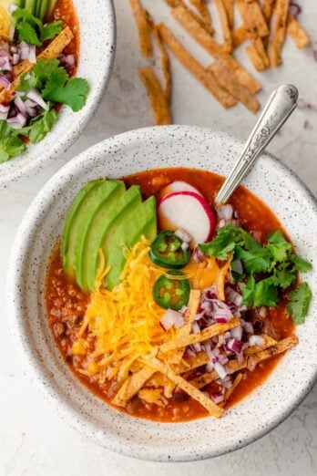 Close up shot of vegetarian tortilla soup with all the toppings