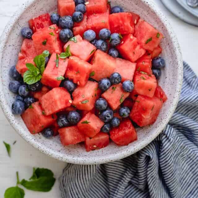 Watermelon Blueberry Salad in a large bowl with mint, honey and lemon juice